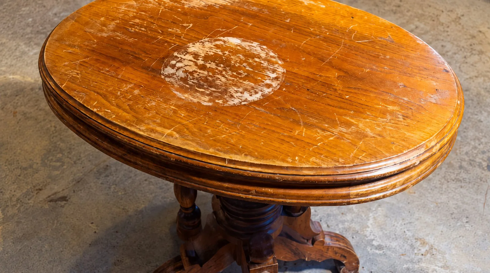 Scratched occasional table with worn finish before restoration